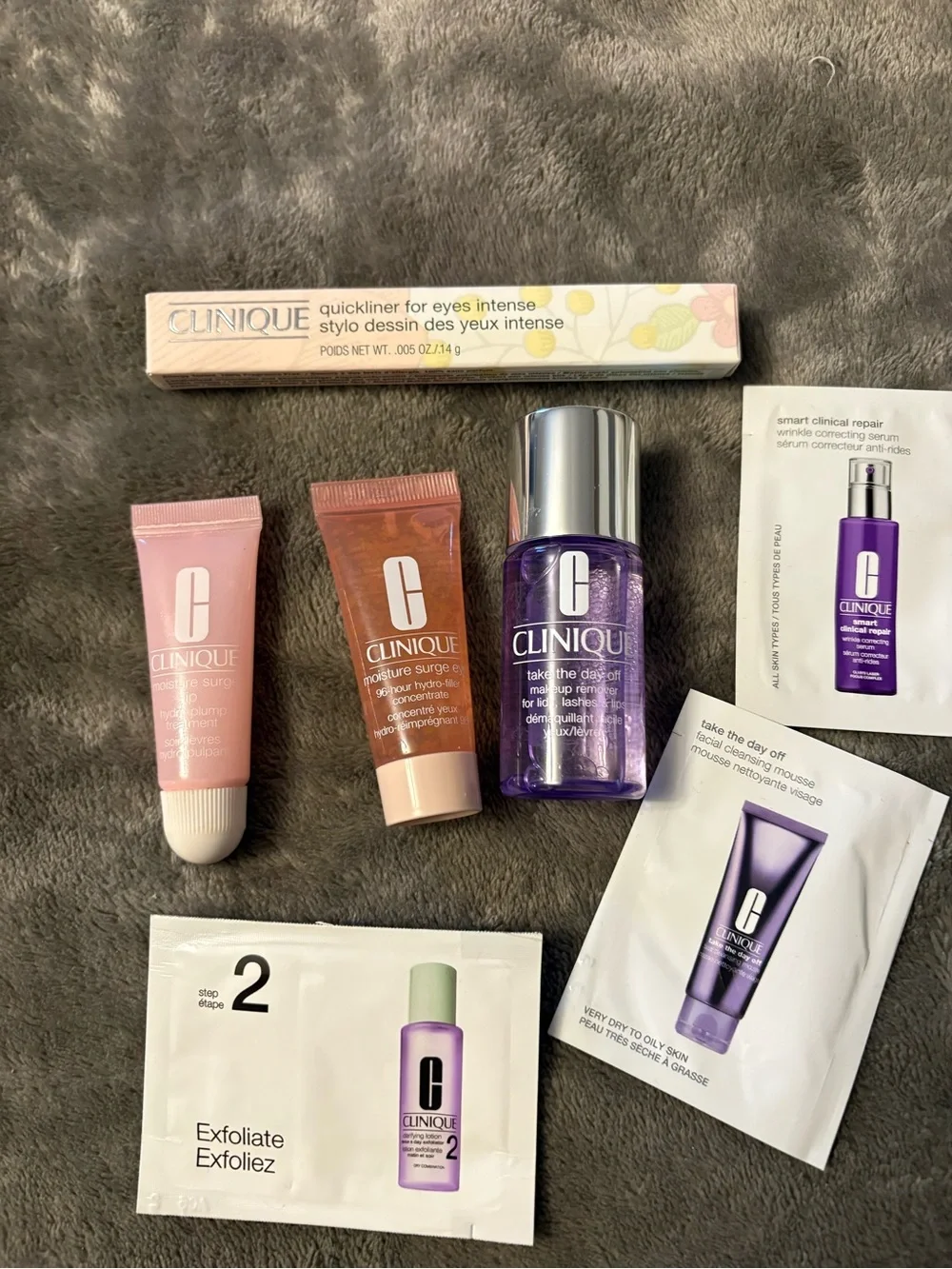 Clinique skincare and eyeliner set — pink, purple, peach, white